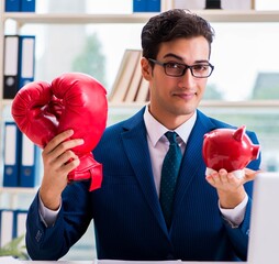 Businessman with boxing gloves angry in office