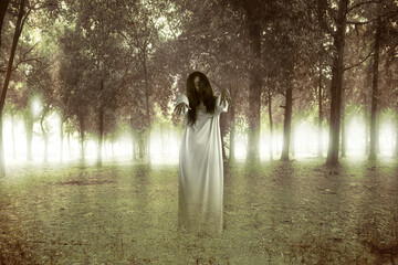 Canvas Print - Scary ghost woman standing with haunted forest background