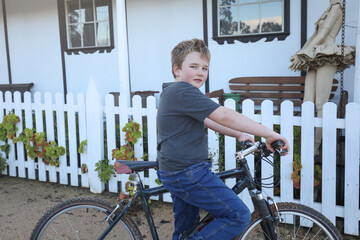 Poster - Boy riding mountain bike without helmet in high country