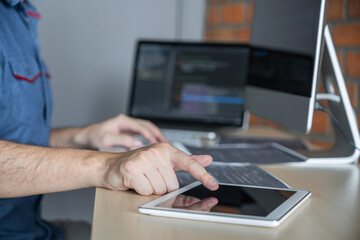 Leinwandbilder - Young Professional programmer working at developing programming and website working in a software develop company office, writing codes and typing data code, Programming with HTML, PHP and javascript