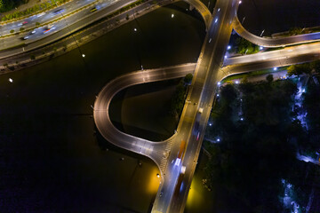 Wall Mural - Aerial view of freeway interchange offramp and bridge over canal with traffic from medium height