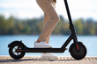 Woman standing on electric scooter