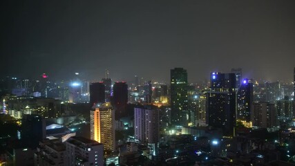 Wall Mural - Timelapse of night Bangkok. Rain in the night city. Clouds float above the night city