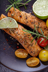 Two baked grilled filet salmon steaks with herbs, tomatoes, lime and spices