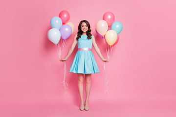 Full size photo of curly charming lady festive clothes event prom party hold both hands many air balloons wear blue teal mini dress skirt high-heels isolated pastel pink color background