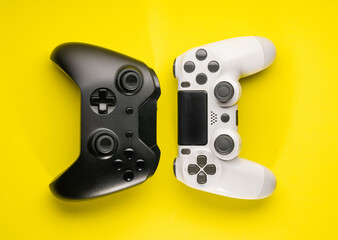 Wall Mural - Black and White game controllers on yellow background