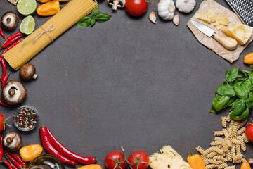 Wall Mural - Italian food cooking ingredients on dark background with copy space.