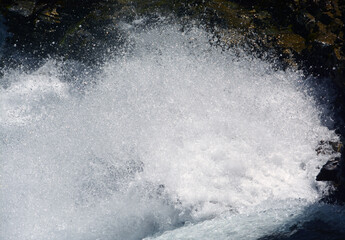 Wall Mural - spectacular water splashes in a mountain waterfall