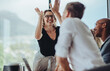 Leinwandbild Motiv Businesswoman giving a high five to a colleague in meeting