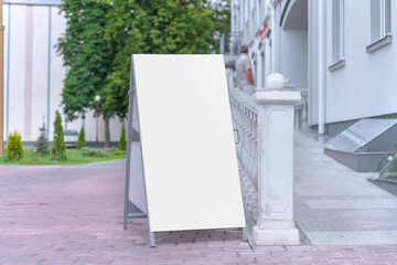 white street banner with blank mockup place on sidewalk near store entrance