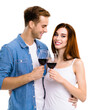 Smiling amorous amazed couple drinking red wine. Portrait image of caucasian models with redwine glasses in love studio concept, isolated over white background. Man and woman together.