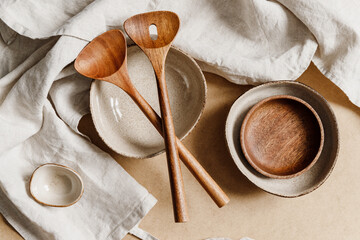 Modern minimalist ceramics set over a linen cloth. Natural products or food concept, top view, flat lay.