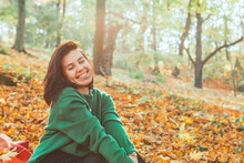 Portrait Of Young Smiling Woman In Autumn Yellow Park