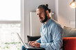 © Petryshak - Young man is working on his laptop. Casual businessman in home office working at his laptop.