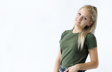 Pretty smiling joyfully female with fair hair, looking with satisfaction at camera, being happy. Beautiful woman isolated against blank studio wall.