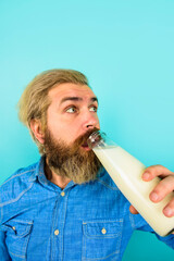 Wall Mural - Milk products. Man drinking milk. Man with bottle of milk. Lactose free milk. Bearded man drinking.