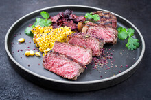 Barbecue Dry Aged Wagyu Roast Beef Steak With Corn And Vegetable Chips Offered As Close-up On A Modern Design Plate