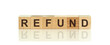 Letter block in word refund on wood white background