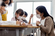 © JR-50 - A group of Kids students wearing medical masks in the classroom.