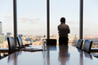 © Martin Barraud/Caia Image - Thoughtful businessman looking out urban conference room window