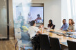 © Martin Barraud/Caia Image - Business people talking and video conferencing in conference room