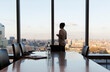 © Martin Barraud/Caia Image - Thoughtful businesswoman at urban highrise office window