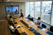 © Chris Ryan/Caia Image - Business people video conferencing in conference room meeting