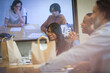 © Tom Merton/Caia Image - Business people with takeout lunch video conferencing in meeting