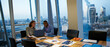 © Chris Ryan/Caia Image - Business people working at laptop in highrise conference room meeting