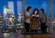 © Martin Barraud/Caia Image - Business people with digital tablet working late at window, London, UK