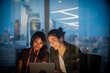 © Tom Merton/Caia Image - Businesswomen with digital tablet working late in office, London, UK