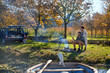 © Trevor Adeline/Caia Image - Happy young couple fishing at sunny autumn riverside
