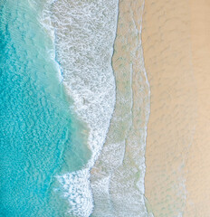 Wall Mural - Aerial view of a beach with nice blue ocean, white sand and idyllic beach.