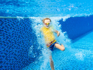 Wall Mural - Child underwater in swimming pool. Kids swim.