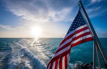 american flag and sunrise over gulf of mexico
