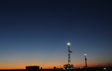 Beautiful sunrise with 2 drilling rigs in the background; West Texas Permian Basin Drilling. If zoomed in, Venus is visible over the rigs.