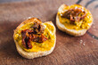 simple food ingredients, bread slices with sweet potoato and kale dip topped with sundried tomatoes