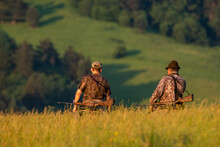 Two Hunters Going For An Evening Hunting In The Mountains