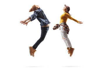 Poster - Full length profile shot of a male and female dancers jumping