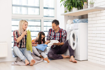 Wall Mural - the image of a happy family doing laundry