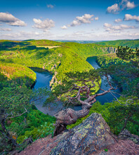 Impressive summer scene from Vyhlidka Maj viewpoint. Horseshoe shape meander of Vltava river. Colorful spring scene in Czech Republic. Beauty of nature concept background..