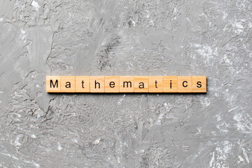 mathematics word written on wood block. mathematics text on cement table for your desing, concept