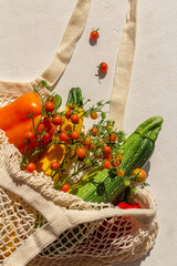 Wall Mural - organic fresh vegetables in a cotton bag on a light background