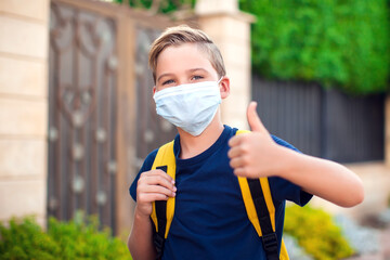 Wall Mural - Pupil with face mask staying outdoor. Back to school. Coronavirus protection