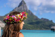 Beautiful woman wearing colorful flower crown while on a tropical island vacation in Bora Bora near Tahiti in French Polynesia