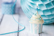 © Ruth Black/Stocksy - Birthday cupcake decorated with a candle