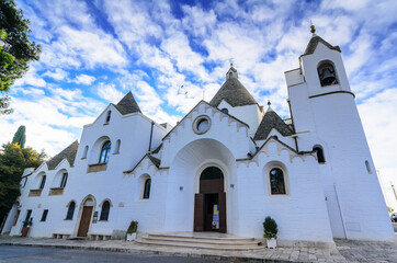 Wall Mural - Church in Alberobello built in the style of Trullo. A trullo is a traditional Apulian dry stone hut with a conical roof.