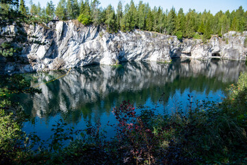 mountain lake with clear green water in granite and marble rocks in a natural monument