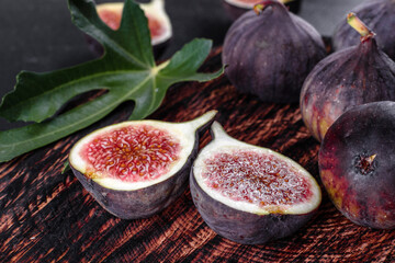 Fresh ripe figs on a dark concrete background. Harvesting figs