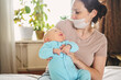 © Алина Троева - Beautiful mother in protective face mask holding her little cute newborn son protecting him from viruses and infections. Coronavirus covid-19 prevention. Home quarantine. Happy family at home.